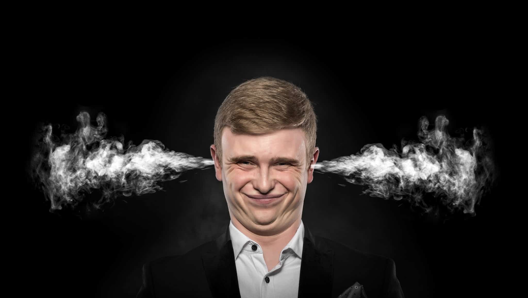 Stressful man with smoke coming out from his ears.