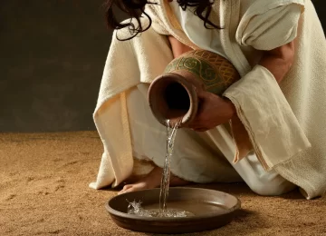 Jesus pouring water from a jar before washing his disciples feet