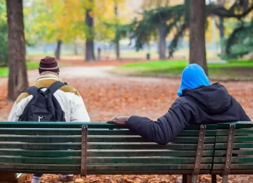 MILAN, ITALY - NOVEMBER, 24: View of two black people sitting on the bench on November 24, 2014