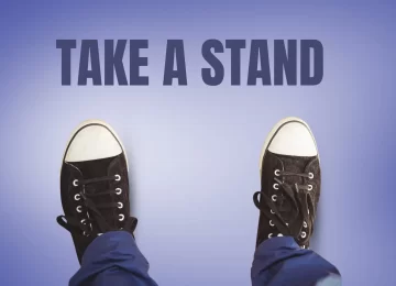 29611460_take-a-stand-text-and-black-shoes-on-feet-with-purple-background