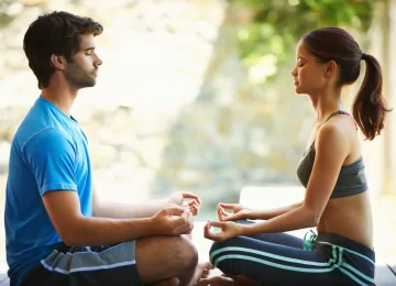 49828002_facing-inner-peace-cropped-view-of-a-two-people-doing-yoga-face-to-face