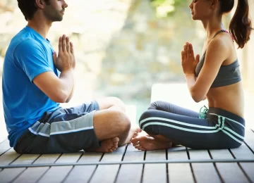 50712832_finding-personal-peace-cropped-view-of-a-two-people-doing-yoga-face-to-face