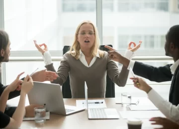 Stressed businesswoman practicing yoga at stressful work, executive woman boss meditating at meeting with diverse employees for keeping mental health and emotional balance, no stress free relief